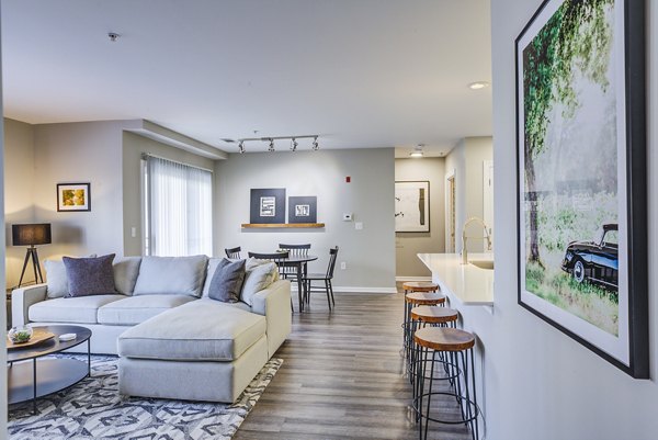 Spacious living room featuring modern furnishings and ample natural light at Pembroke Woods Apartments