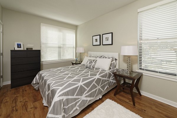 The Aspen Apartments: Modern bedroom with elegant bedding and natural light, luxury living at Greystarâ€™s prime location