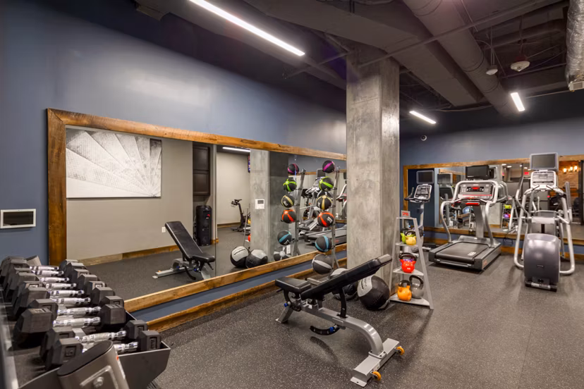Aspen Apartments: Modern fitness center with state-of-the-art equipment in a luxury setting