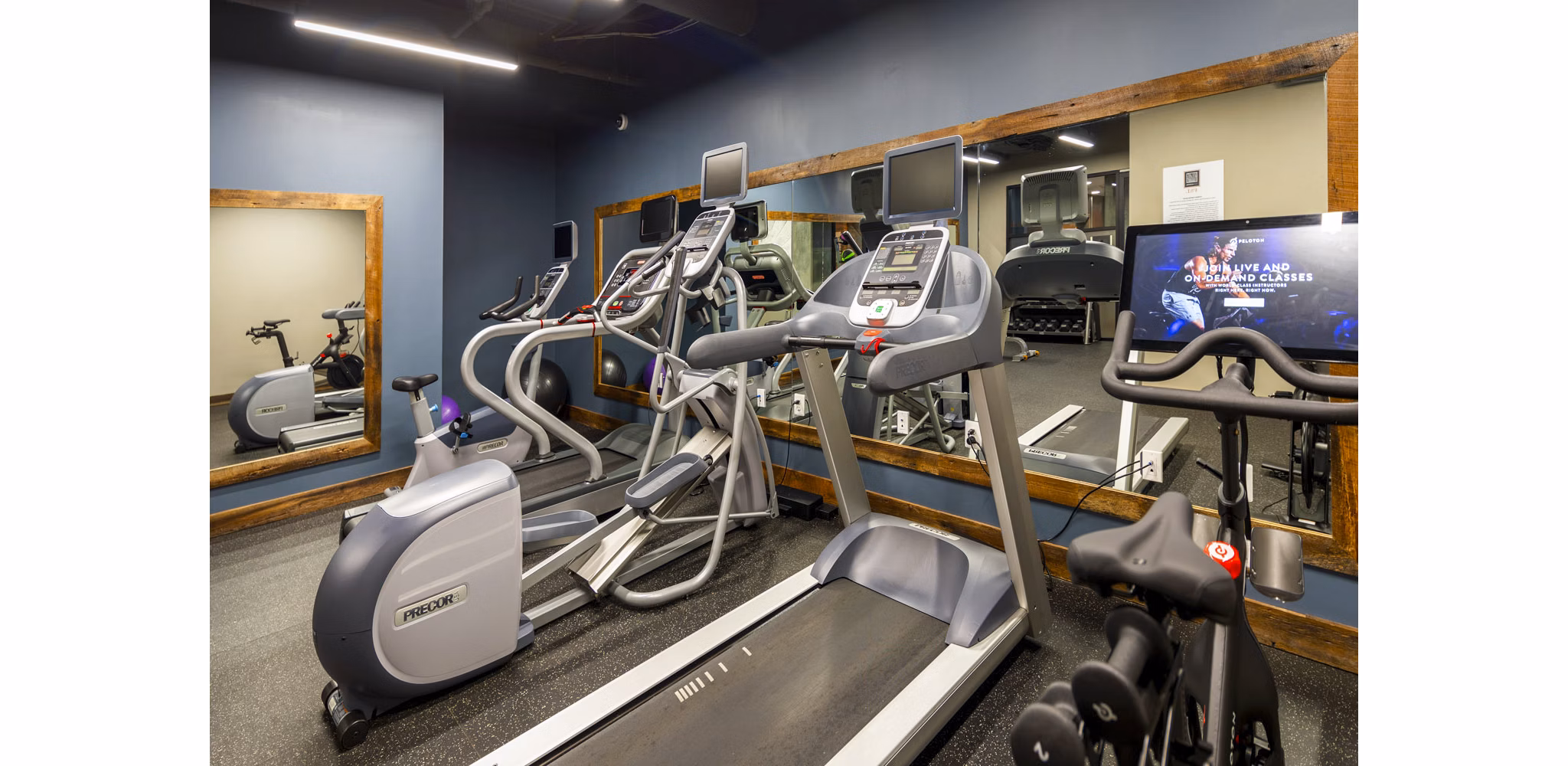 Fitness center with modern equipment at The Aspen Apartments