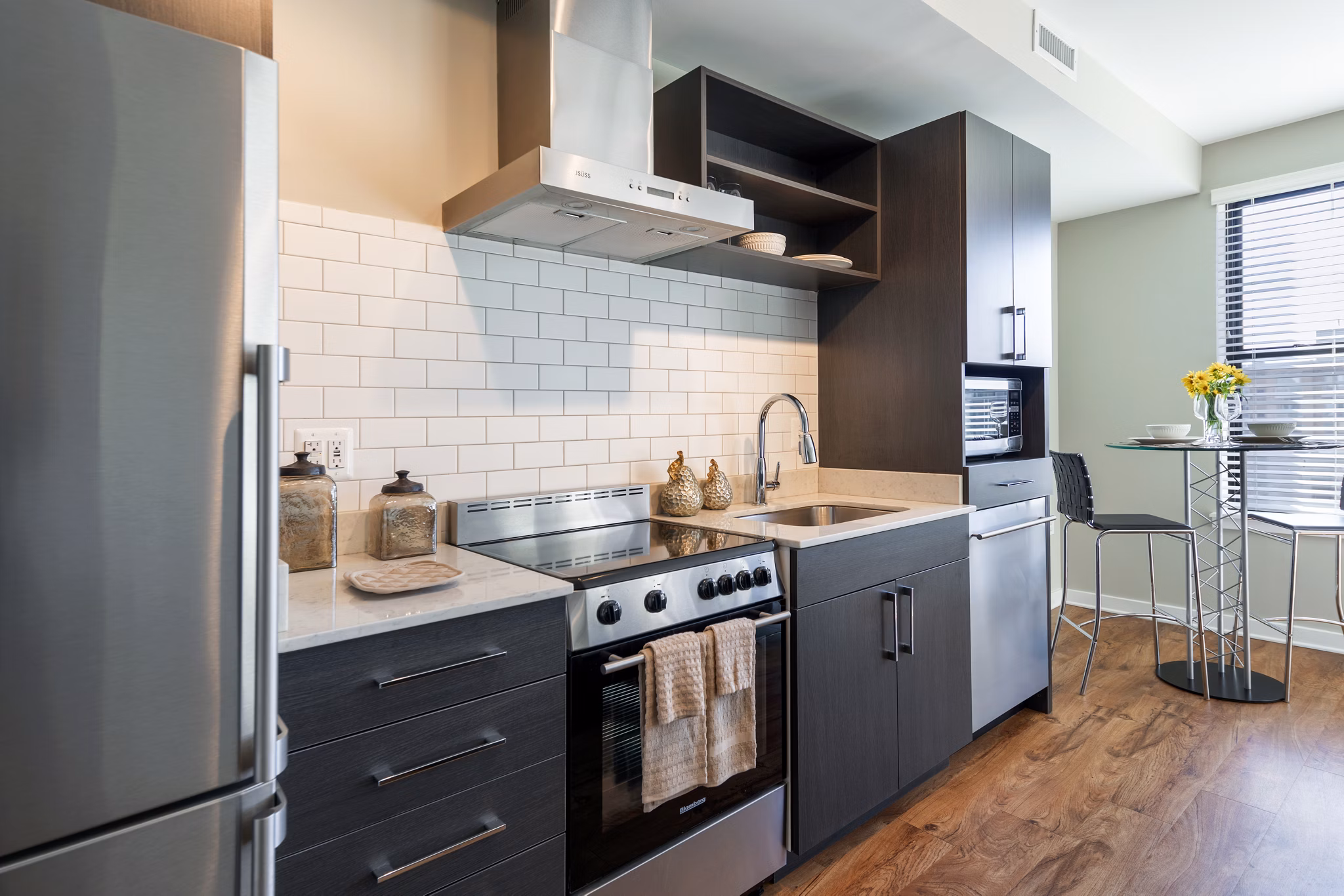 Kitchens with granite countertops and stainless steel appliances at The Aspen Apartments