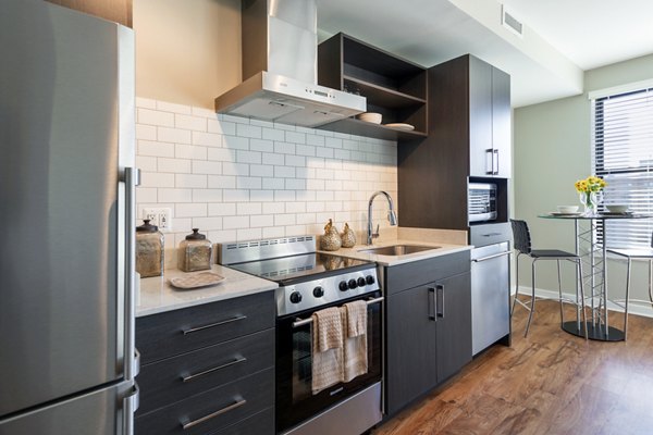 Kitchens with granite countertops and stainless steel appliances at The Aspen Apartments