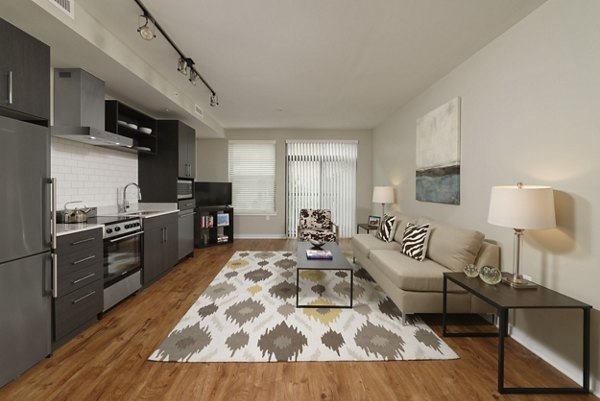 Spacious living room with modern decor at The Aspen Apartments in downtown, perfect for urban living