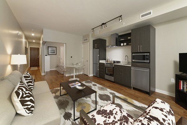 Cozy living room with a chic modern design at The Aspen Apartments, featuring plush seating and accent decor