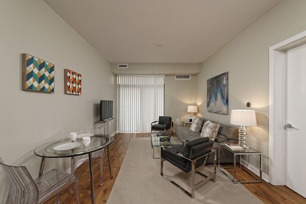Spacious living room with modern decor at The Aspen Apartments, offering luxury lifestyle and comfort in a Greystar-managed property