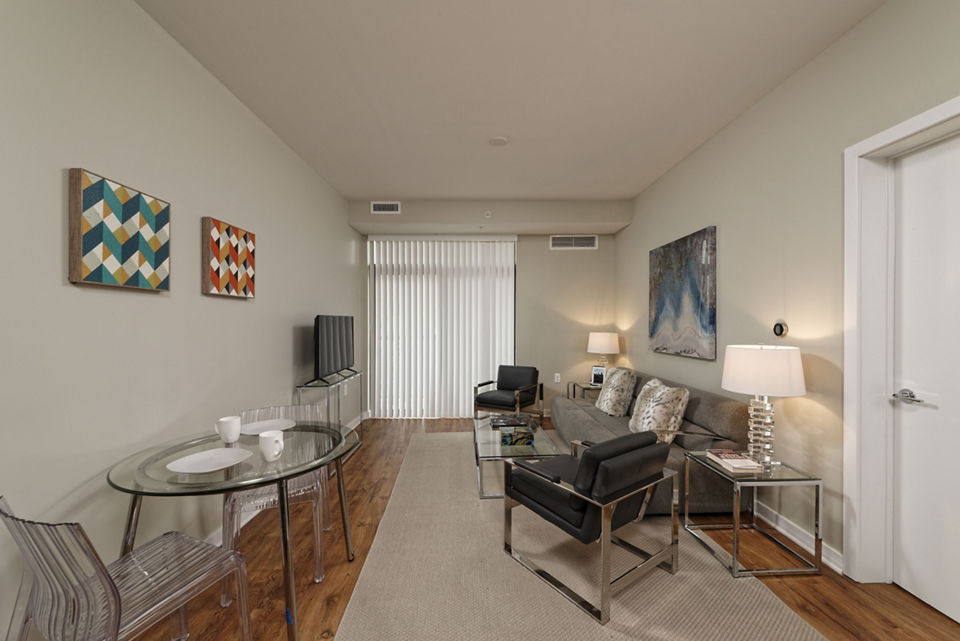 Spacious living room with modern decor at The Aspen Apartments, offering luxury lifestyle and comfort in a Greystar-managed property