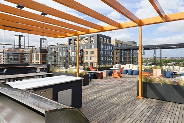 Scenic rooftop patio with comfortable seating at The Aspen Apartments, providing panoramic city views for luxury living