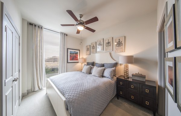 Nouvelle Apartments: Modern bedroom with stylish decor and ample natural light in our luxury community