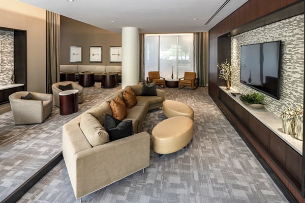 Spacious living room with modern sofas and a large TV in luxury apartments
