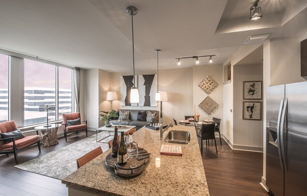 Nouvelle Apartments: Modern kitchen with stainless steel appliances and granite countertops