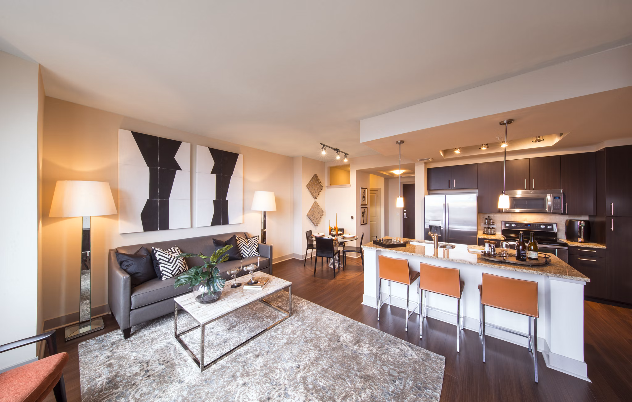 Spacious living room with modern decor at Nouvelle Apartments featuring luxury finishes