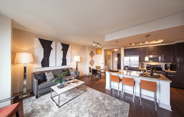 Spacious living room with modern decor at Nouvelle Apartments featuring luxury finishes