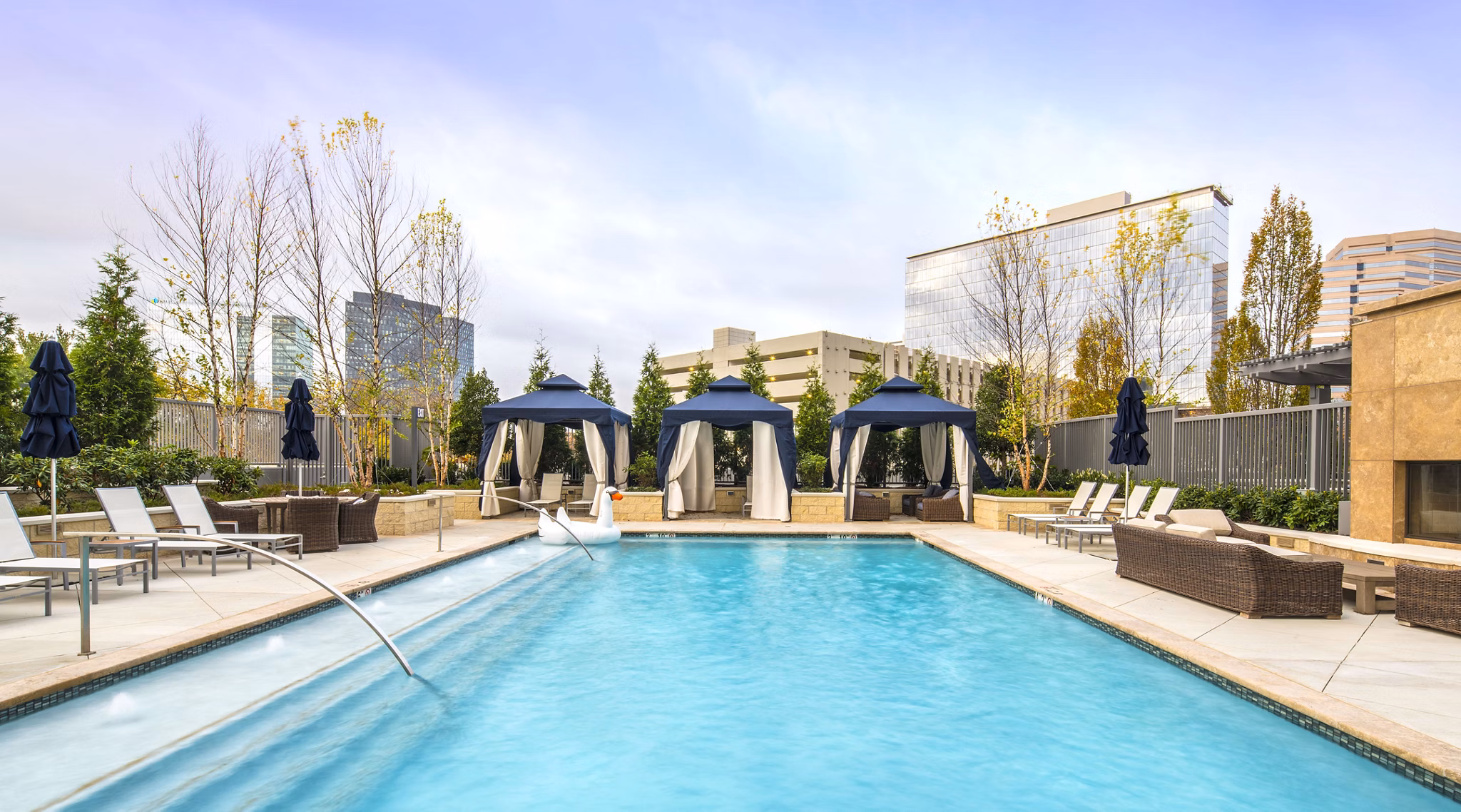 Around a pool deck with modern sun loungers at Nouvelle Apartments