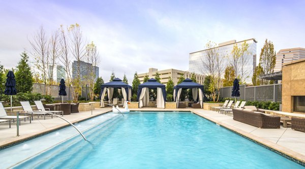 Around a pool deck with modern sun loungers at Nouvelle Apartments