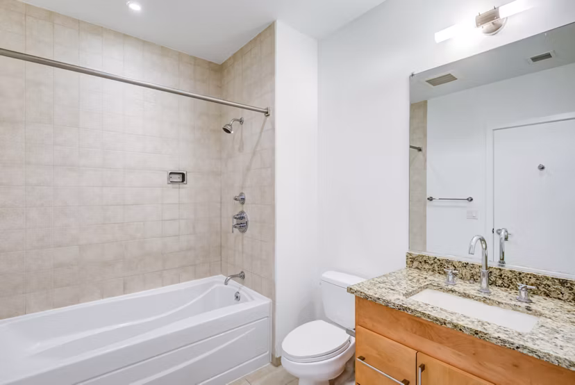 Modern bathroom with dual sinks and elegant fixtures in The Lofts at Park Crest Apartments