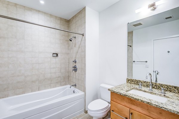 Modern bathroom with dual sinks and elegant fixtures in The Lofts at Park Crest Apartments
