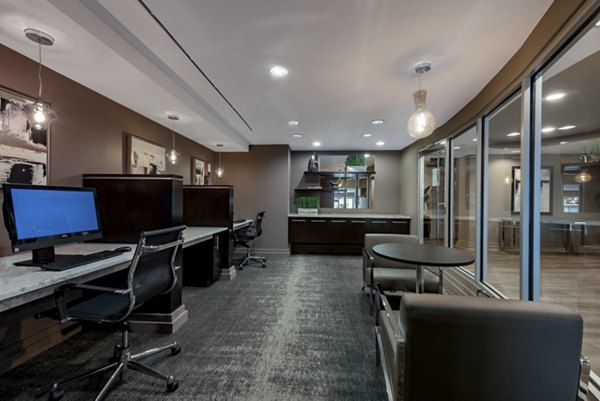 Game room equipped with pool table and lounge seating at The Lofts at Park Crest Apartments in a stylish setting for socializing and relaxation