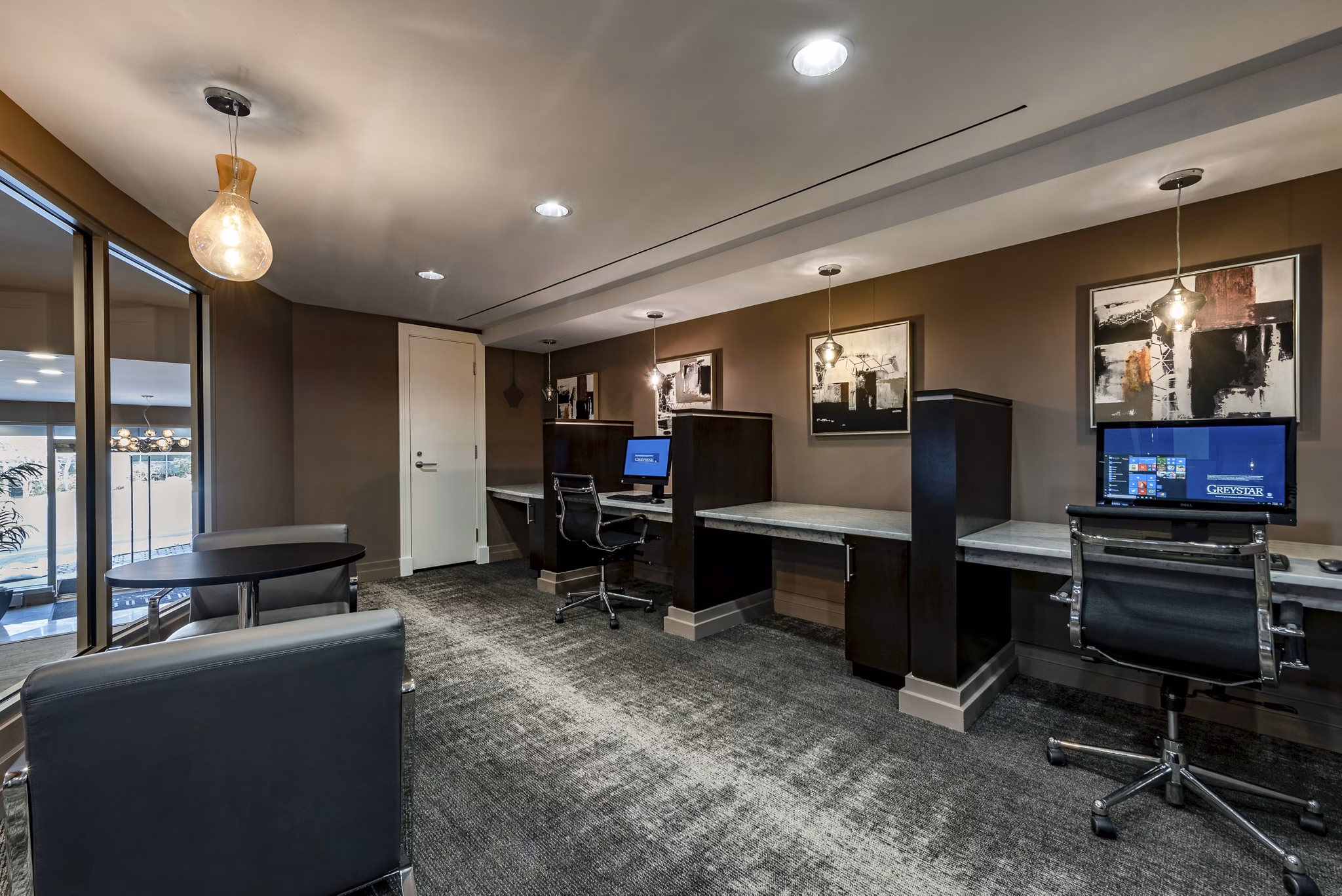 Game room with billiards and lounge chairs at The Lofts at Park Crest Apartments, ideal for entertainment and relaxation