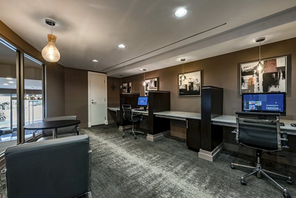 Game room with billiards and lounge chairs at The Lofts at Park Crest Apartments, ideal for entertainment and relaxation