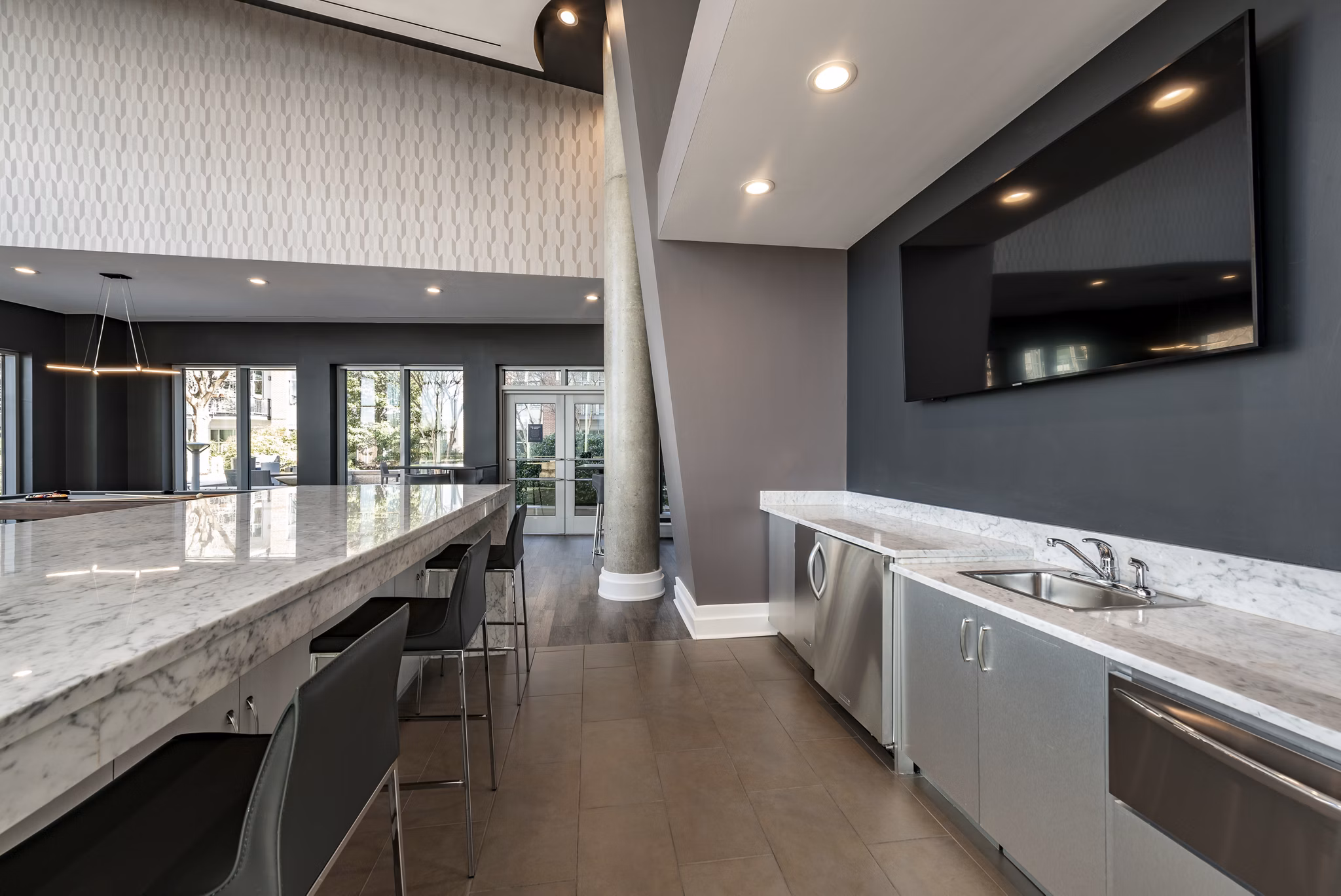 Clubhouse with modern seating and entertainment space at The Lofts at Park Crest Apartments, offering luxury living in a vibrant community