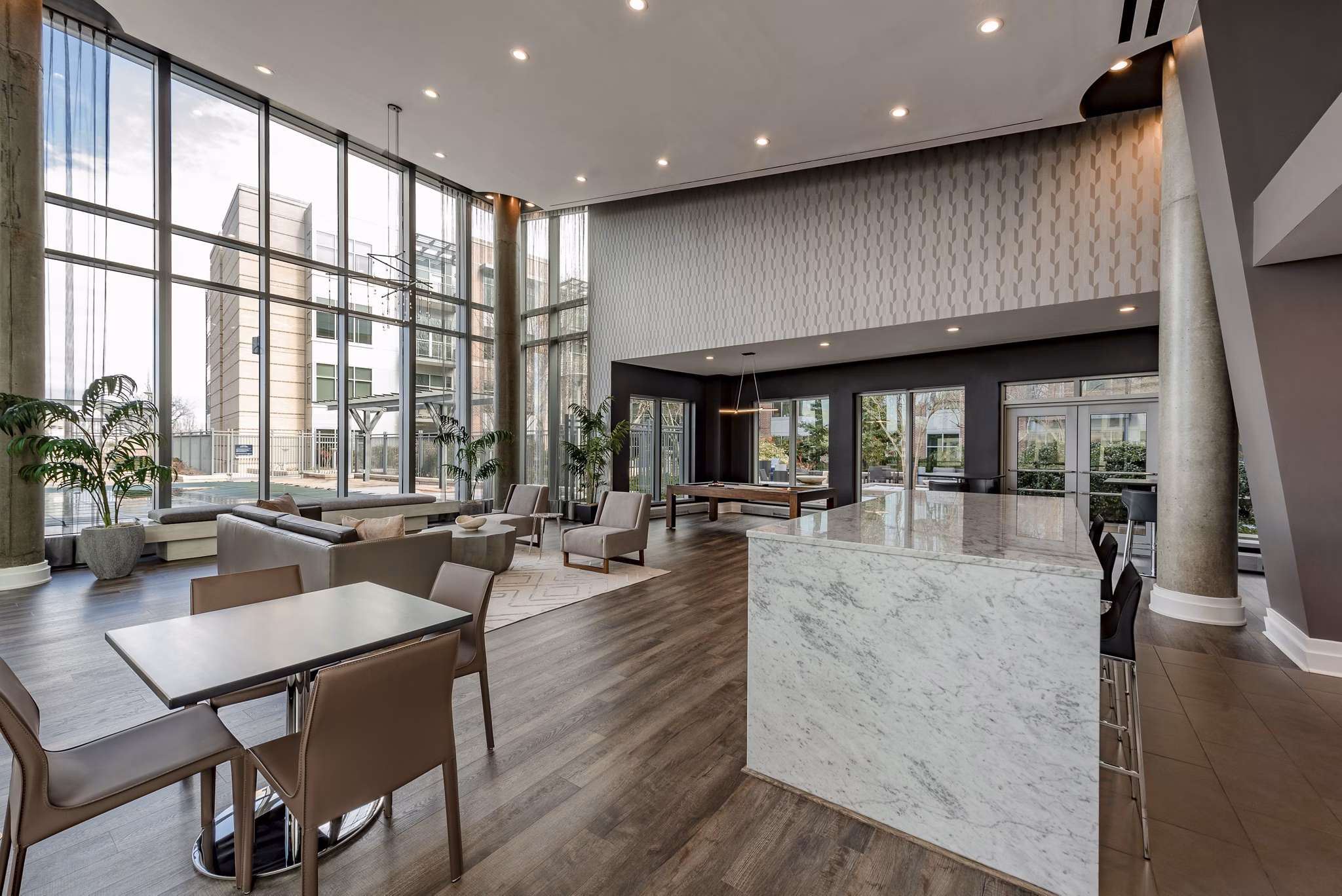 Modern clubhouse with plush seating and pool table at The Lofts at Park Crest Apartments