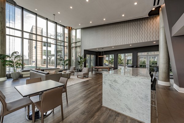 Modern clubhouse with plush seating and pool table at The Lofts at Park Crest Apartments