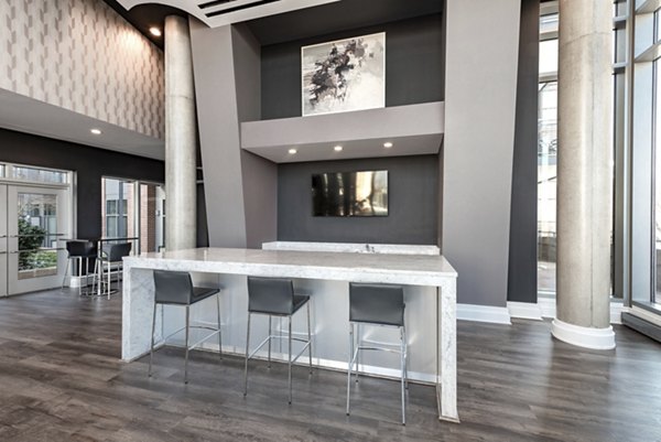 Clubhouse with modern design and ample seating at The Lofts at Park Crest Apartments, ideal for social gatherings and community events