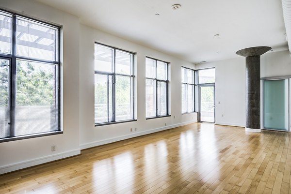 Chic living room with sleek design and large windows at The Lofts at Park Crest Apartments