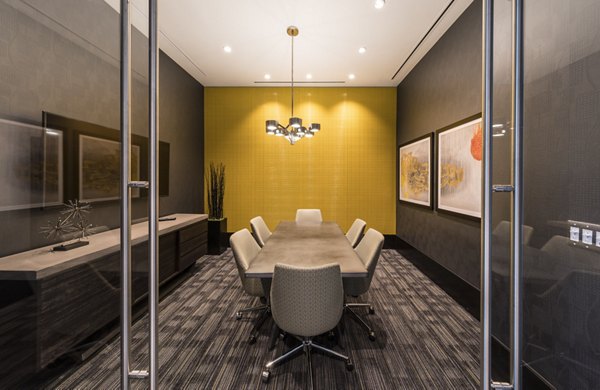 Clubhouse interior with modern seating and large-screen TVs at Latitude Apartments, a luxury living space