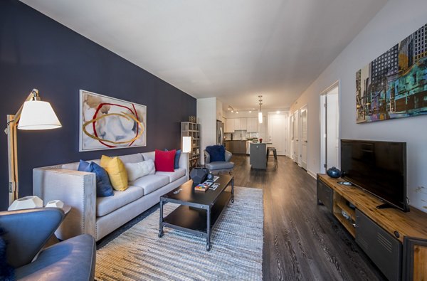Cozy living room with modern dÃ©cor and natural light in Latitude Apartments