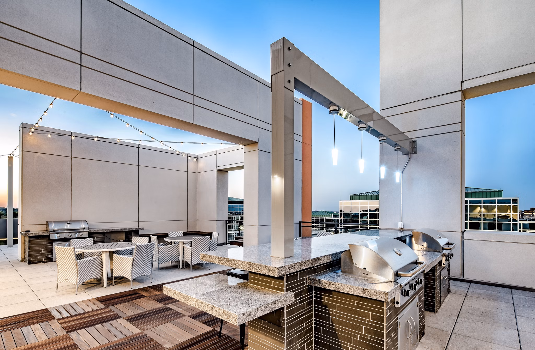 Modern rooftop grill station with panoramic city views at Latitude Apartments