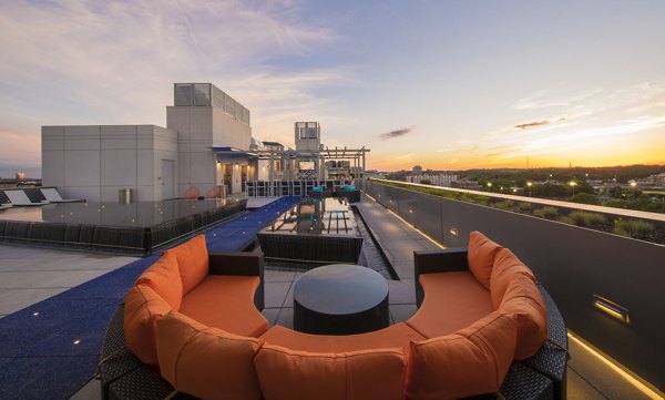 Rooftop patio with modern seating and city views at Latitude Apartments