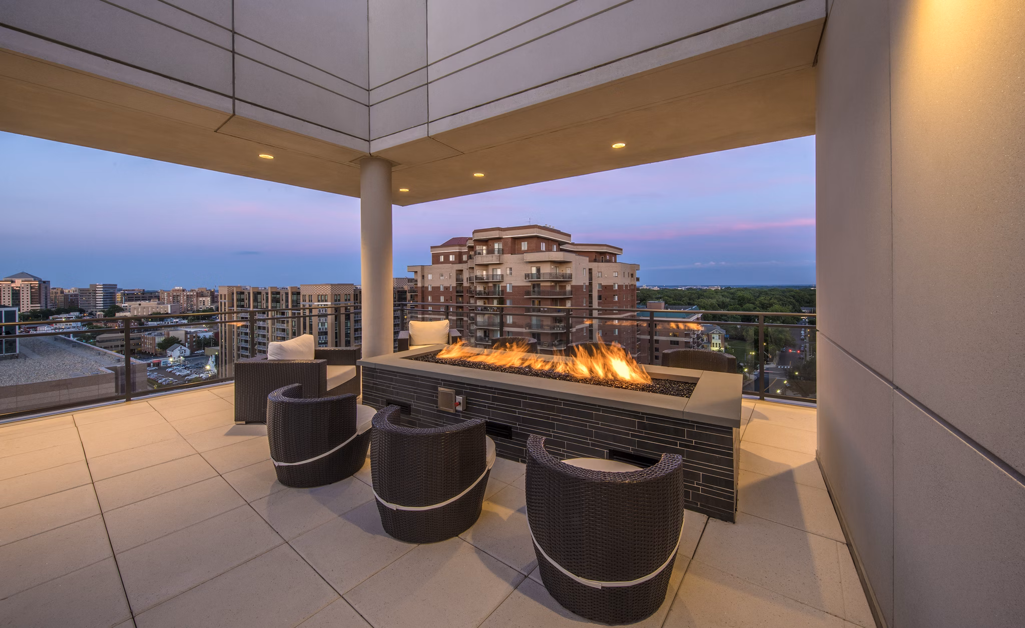 Scenic rooftop patio with lounge seating at Latitude Apartments, offering stunning skyline views