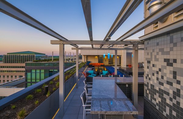 Relaxing rooftop patio with panoramic city views at Latitude Apartments