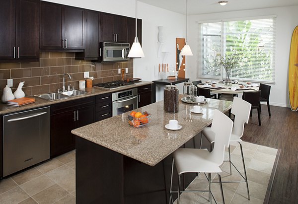 Modern kitchen featuring stainless steel appliances and quartz countertops at Forty55 Lofts luxury apartments