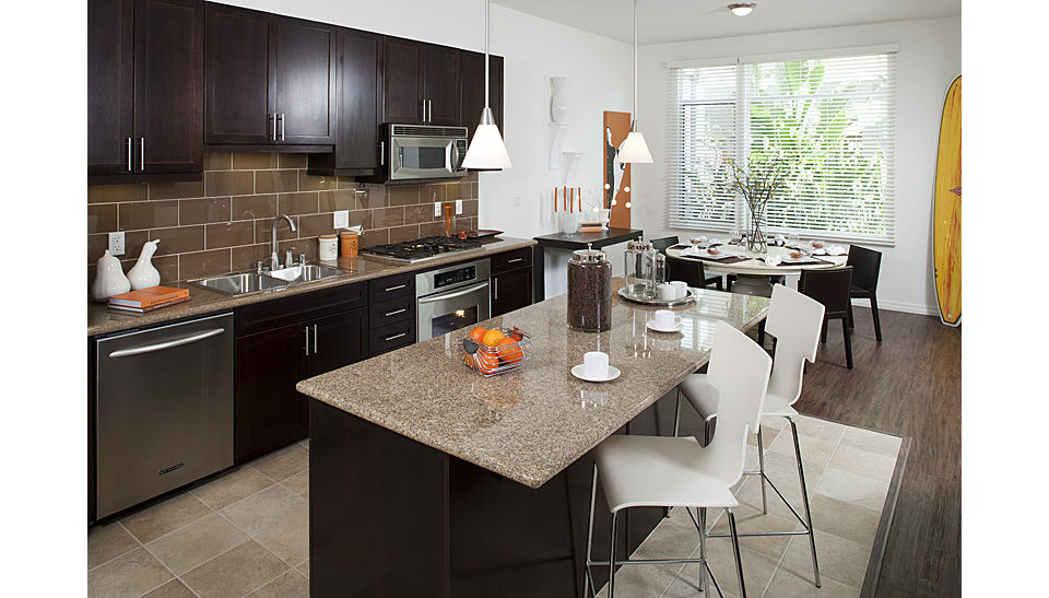 Modern kitchen featuring stainless steel appliances and quartz countertops at Forty55 Lofts luxury apartments