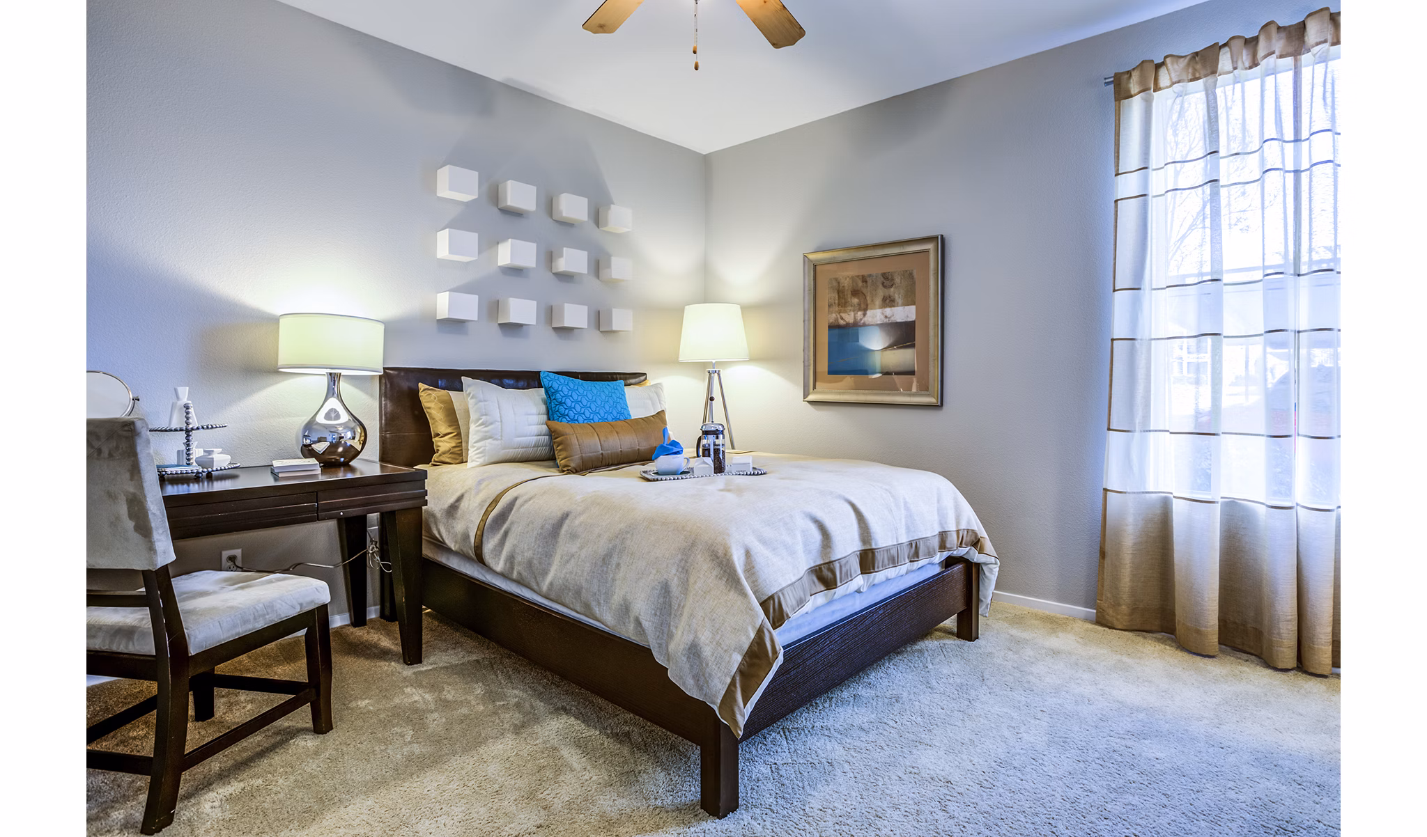 Bedroom with cozy decor featuring large windows at Acacia on Santa Rosa Creek Apartments
