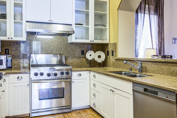 Acacia on Santa Rosa Creek Apartments: Modern clubhouse kitchen with sleek countertops and stainless steel appliances