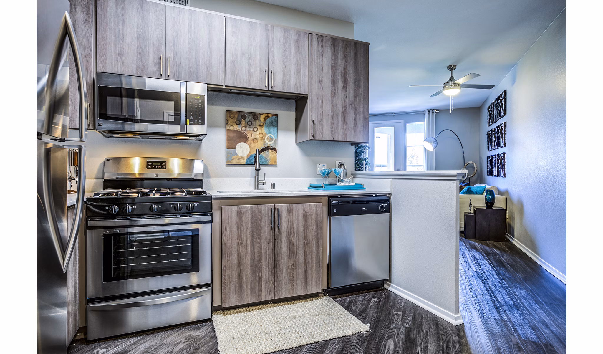 Modern kitchen with stainless steel appliances at Acacia on Santa Rosa Creek Apartments