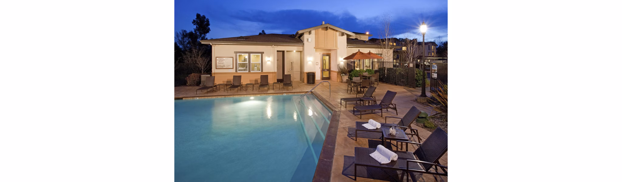 Resort-style pool with lounge chairs at Acacia on Santa Rosa Creek Apartments