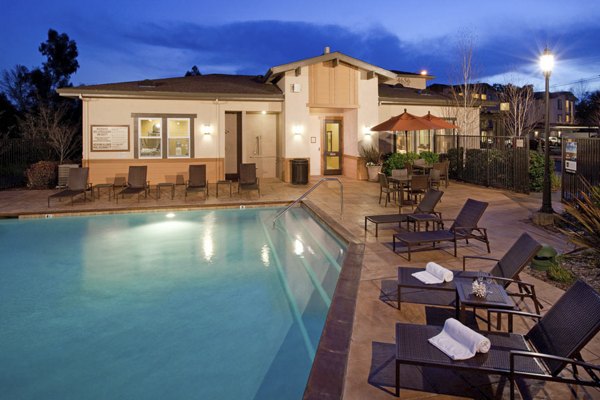 Resort-style pool with lounge chairs at Acacia on Santa Rosa Creek Apartments