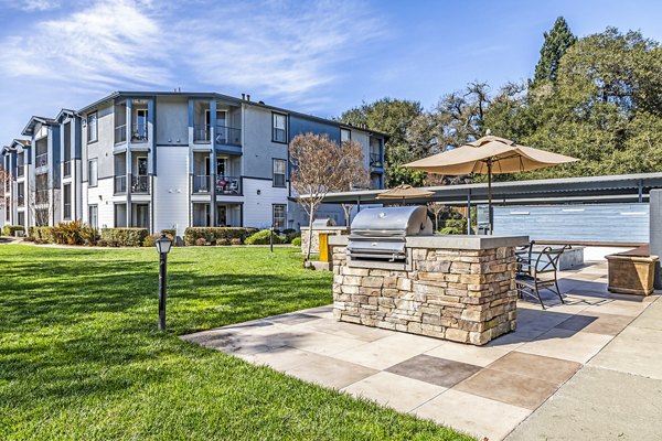 Grill area with modern barbeque equipment at Acacia on Santa Rosa Creek Apartments