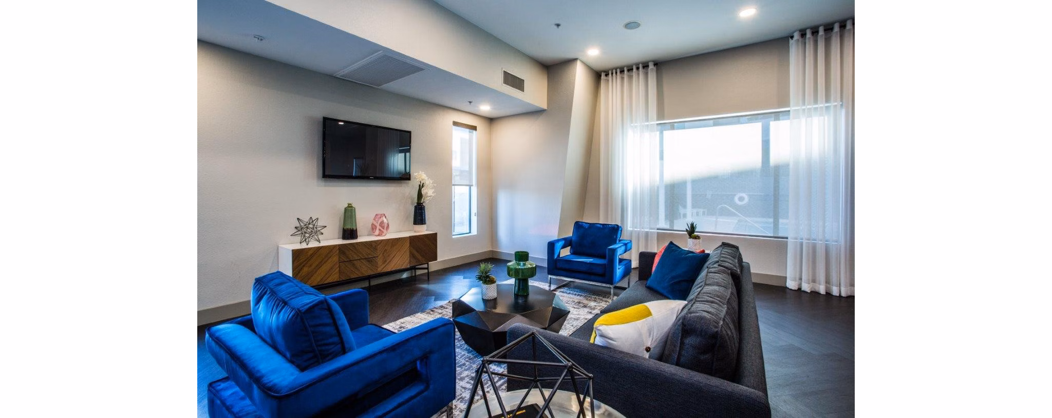 Clubhouse at Glo Las Vegas Apartments: Modern social space with seating and entertainment options, fostering community and relaxation