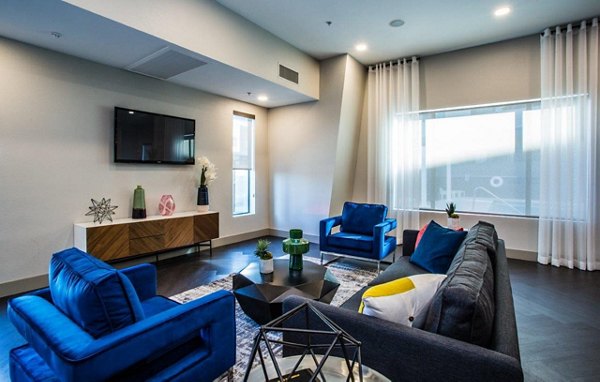 Clubhouse at Glo Las Vegas Apartments: Modern social space with seating and entertainment options, fostering community and relaxation