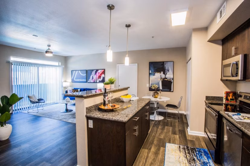 Modern kitchen featuring stainless steel appliances and granite countertops at Glo Las Vegas Apartments