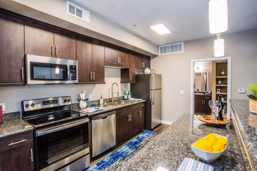 Modern kitchen with sleek appliances and island seating at Glo Las Vegas Apartments, perfect for luxury living