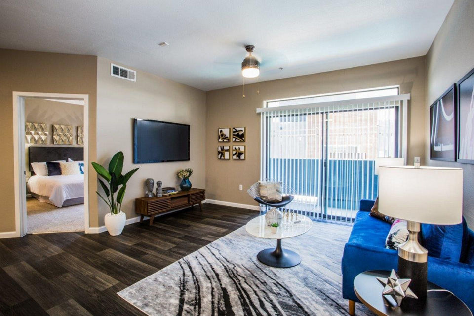 Spacious living room with modern decor and large windows in Glo Las Vegas Apartments