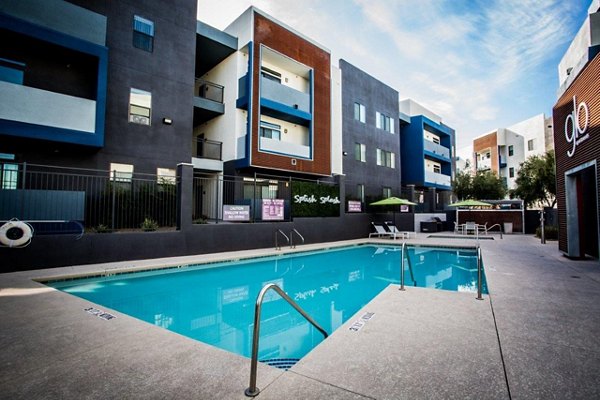 Poolside relaxation at Glo Las Vegas Apartments with luxurious seating and stylish outdoor decor