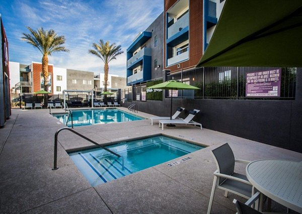 Relaxing hot tub with pristine water at Glo Las Vegas Apartments, ideal for unwinding in luxury