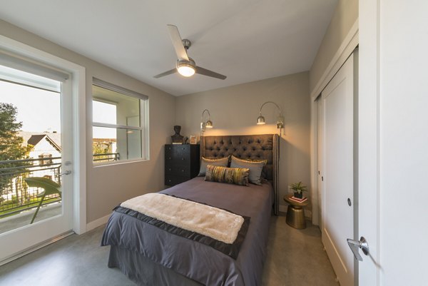 Large bedroom with modern decor at The Desmond Apartments